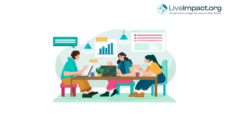 Nonprofit team collaborating on data and reports using LiveImpact software at a meeting table
