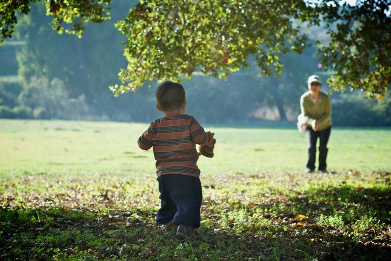 Two young children playing together outdoors, symbolizing family support and community care provided by nonprofit organizations.